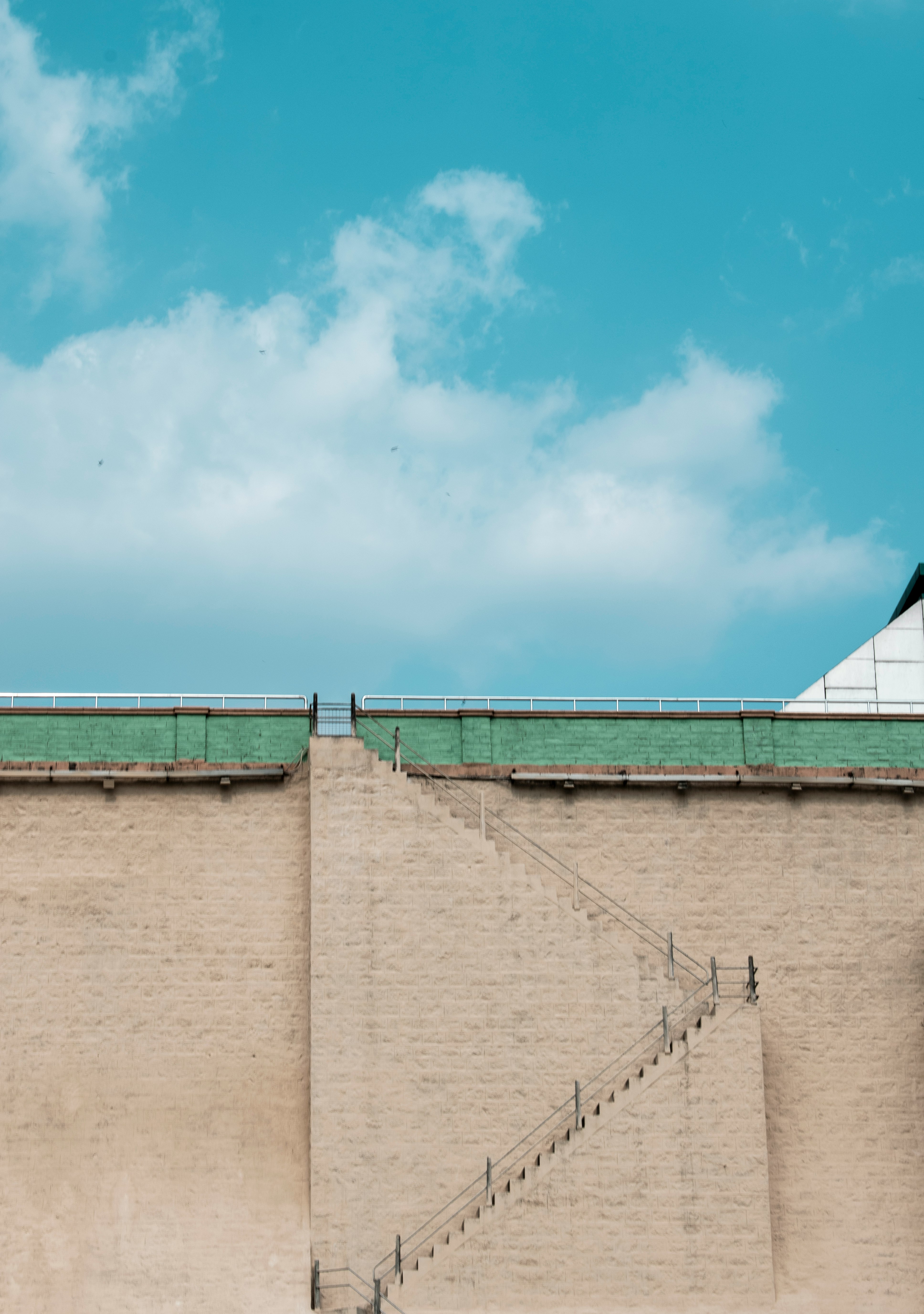 brown concrete wall under blue sky during daytime